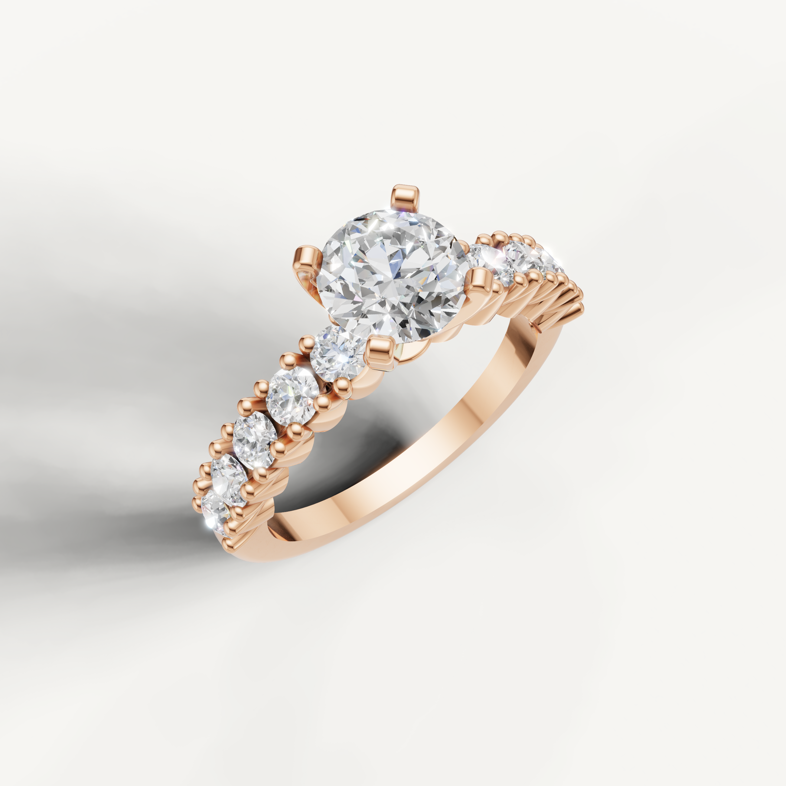 Round cut diamond ring in rose gold with side diamonds by Raul Diamonds
