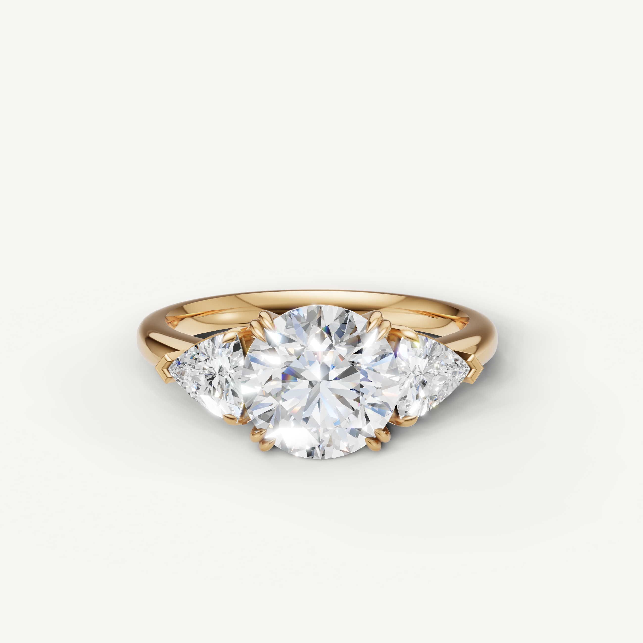 round brilliant lab grown diamond engagement ring with trillion side stones in 14k yellow gold