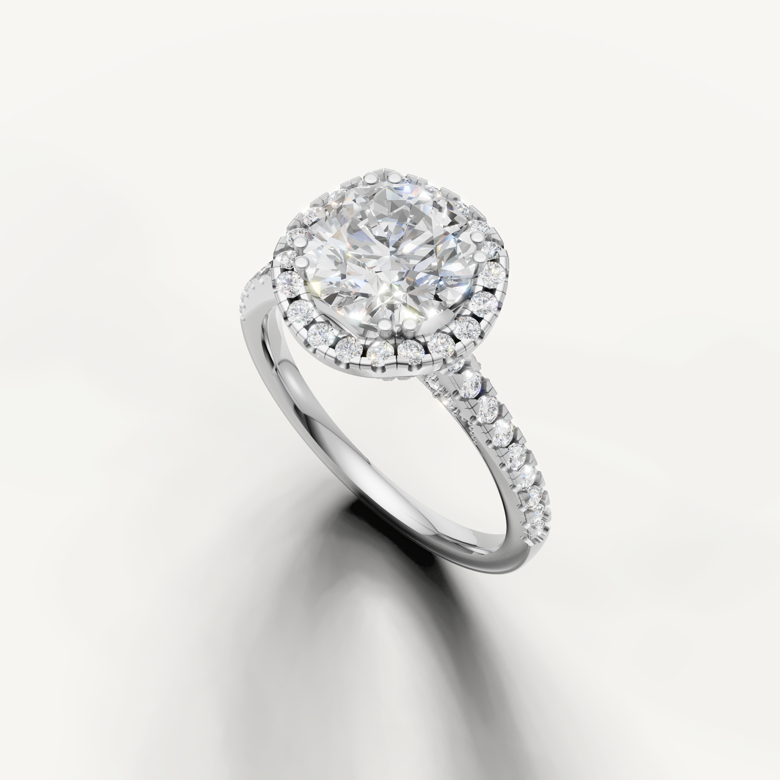 White gold round cut lab grown diamond ring featuring a timeless halo setting and sparkling pavé band