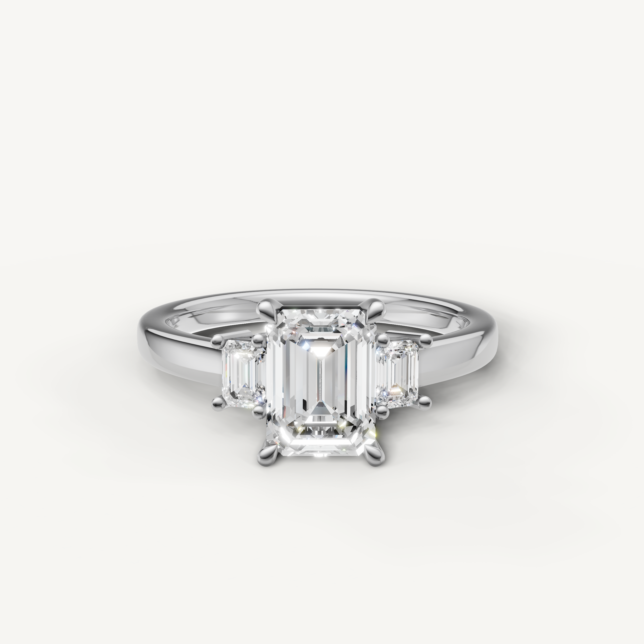 Emerald cut lab grown diamond three stone engagement ring in 14K white gold with step cut side stones