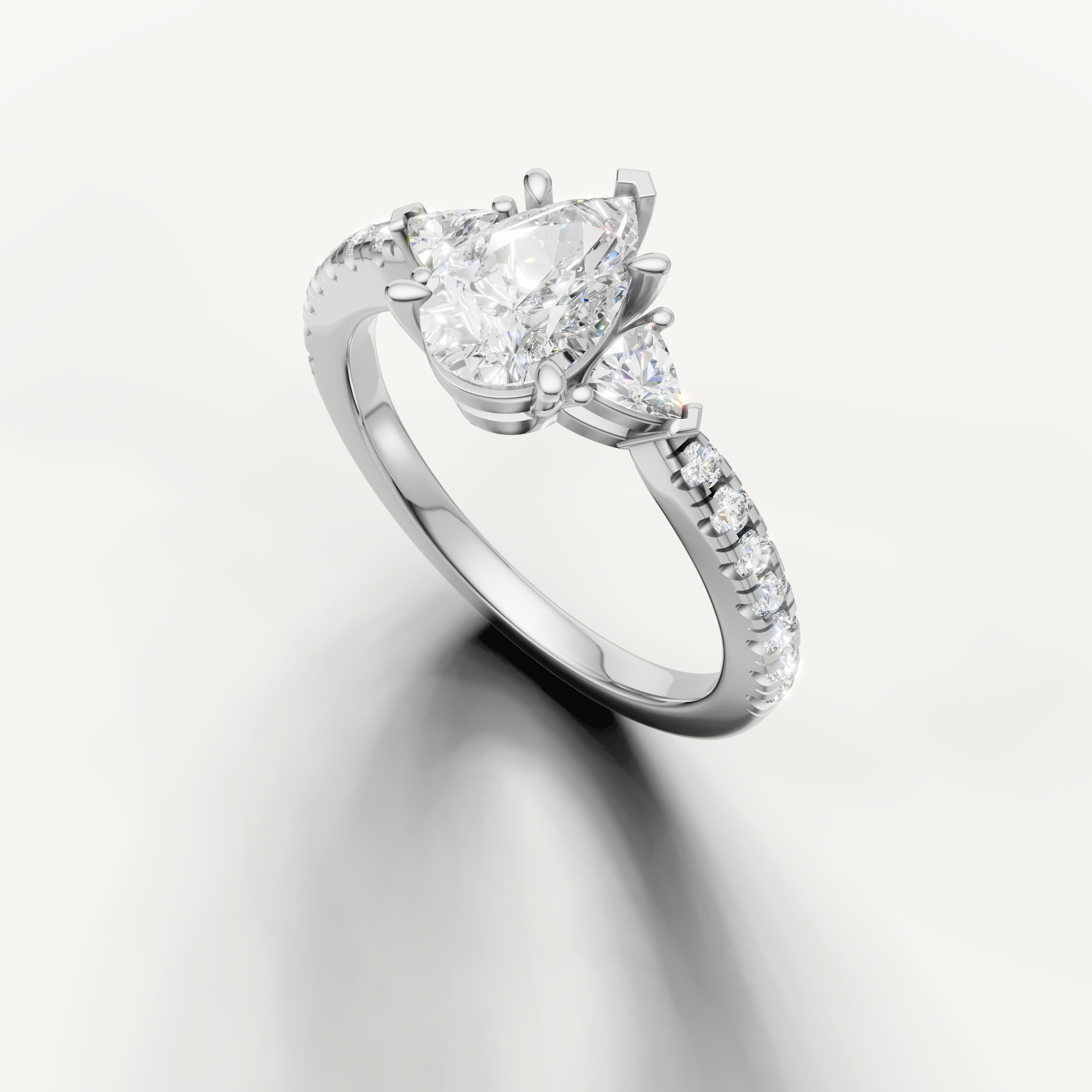 Classic pear cut three-stone lab grown diamond ring in white gold with pavé band