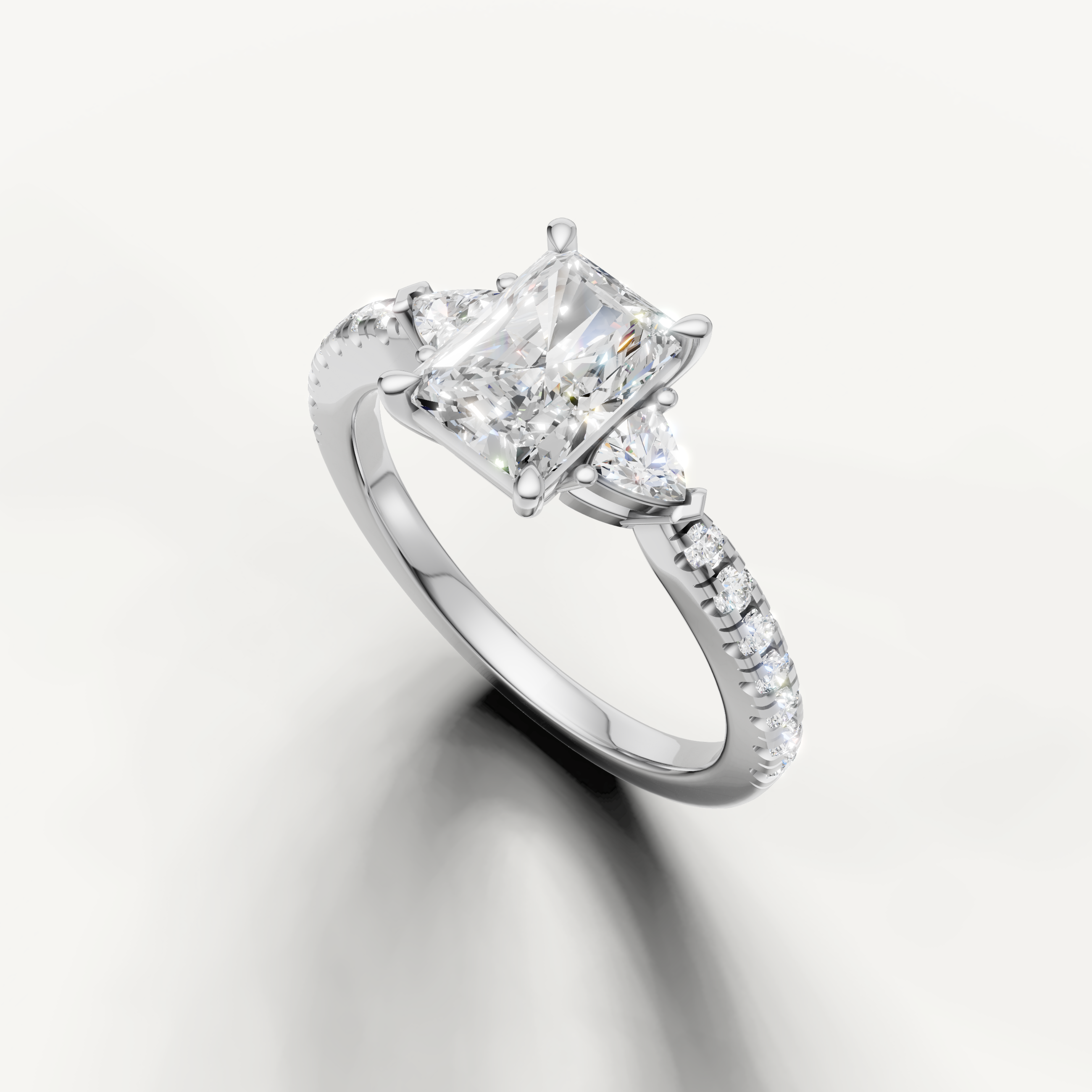 Radiant cut three-stone lab grown diamond engagement ring in white gold with slim pavé band