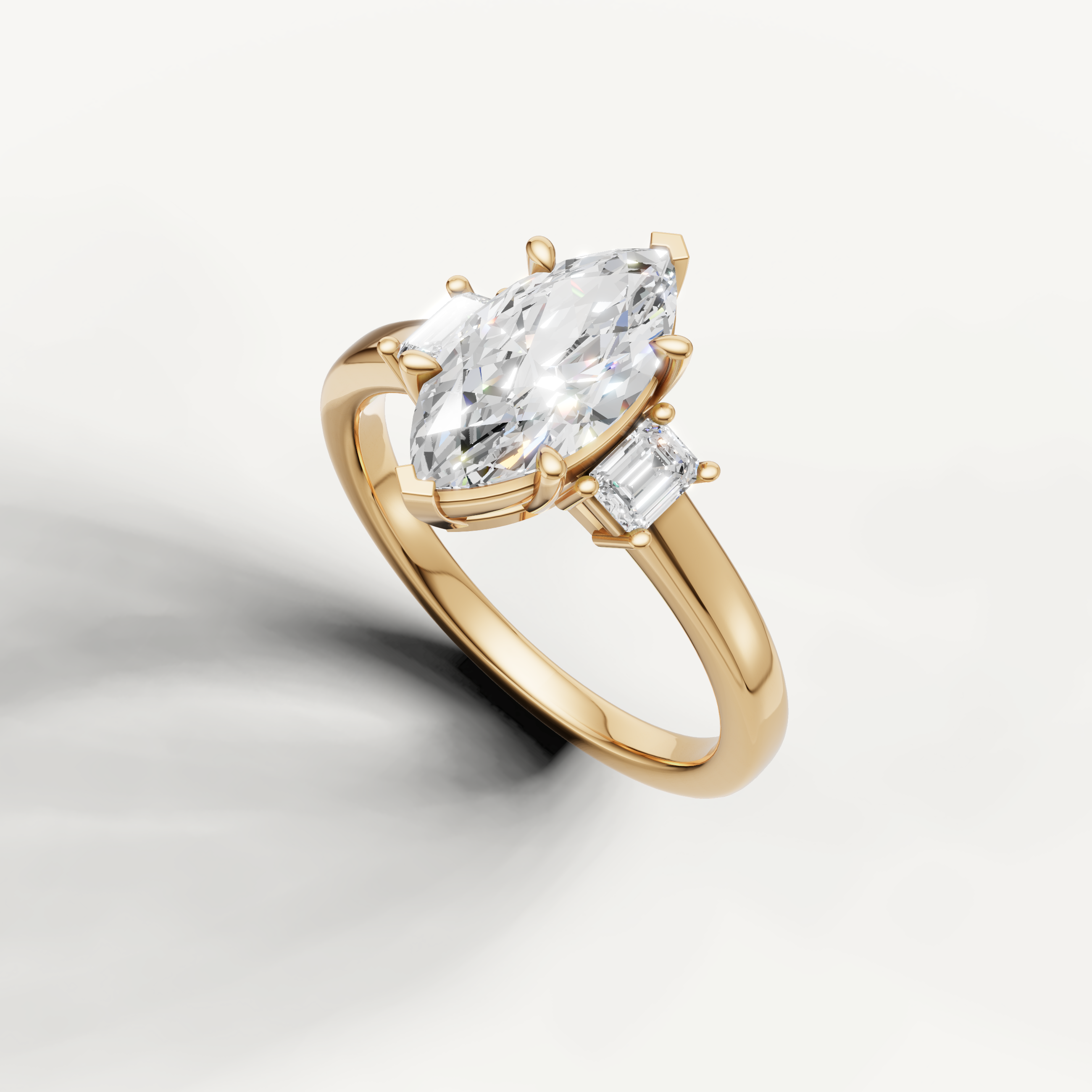 Modern marquise cut three stone lab grown diamond ring in yellow gold with minimalist design