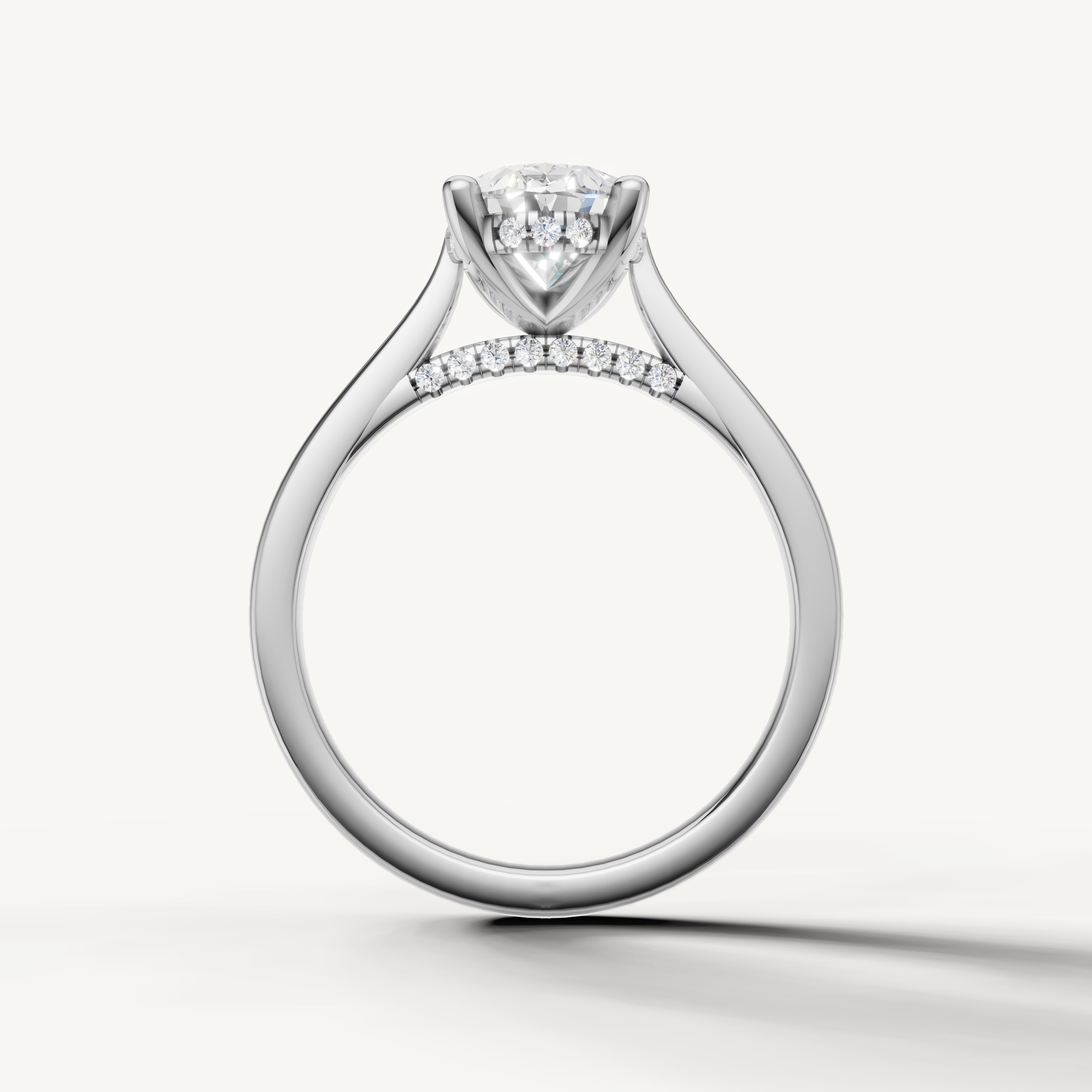 Raul Diamonds bespoke oval ring featuring a hidden halo of diamonds and a four-prong claw setting.