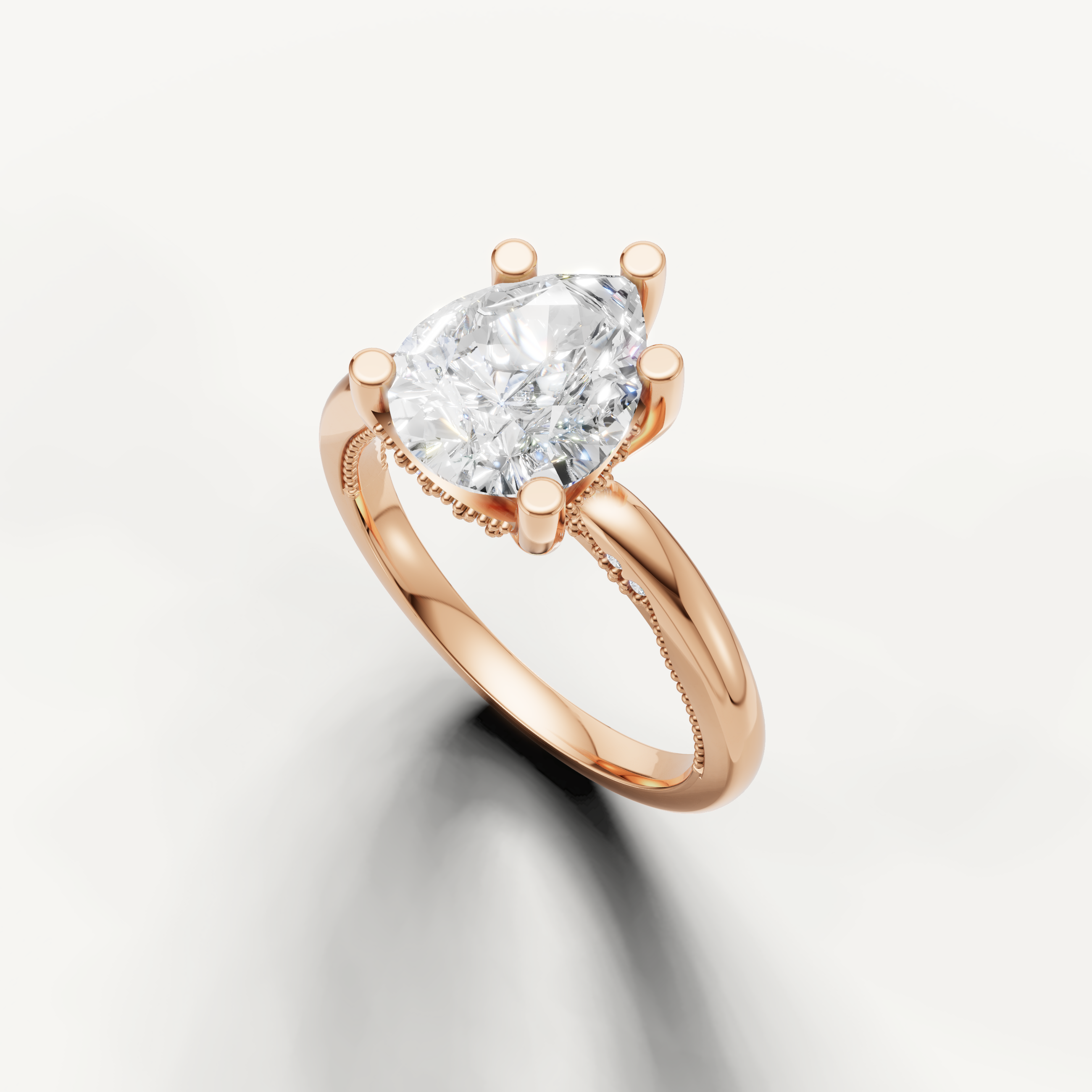A smooth, minimalist rose gold band set with a radiant pear-cut diamond, offering a warm and distinctive aesthetic.