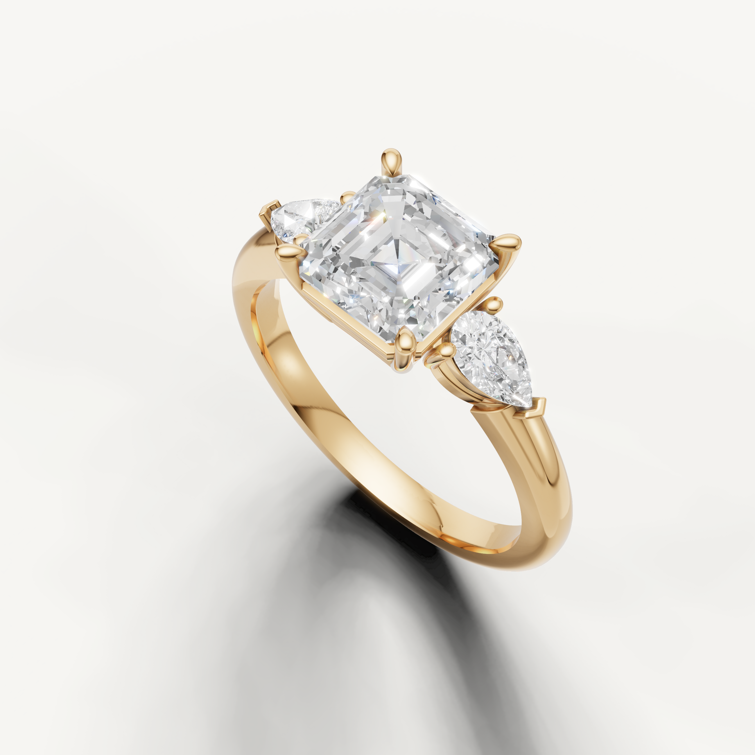 step cut asscher diamond ring with pear side stones yellow gold
