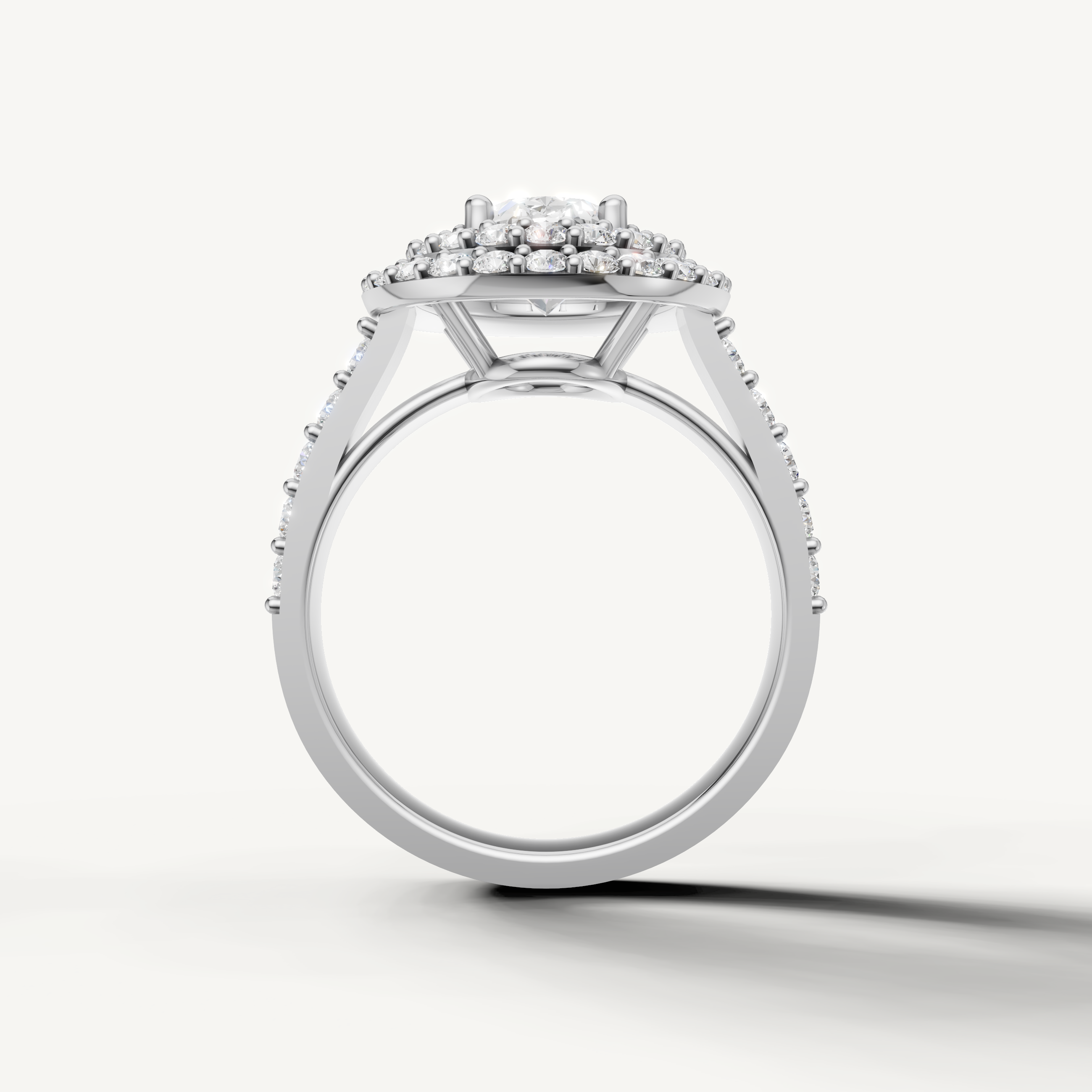 Oval center diamond ring with shimmering halo and pavé diamonds from Raul Diamonds