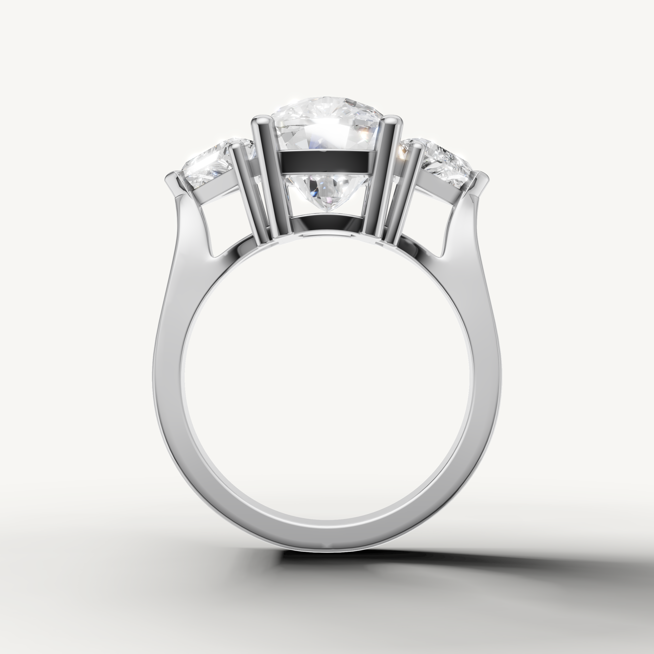 Round center diamond ring with sparkling pear side diamonds from Raul Diamonds