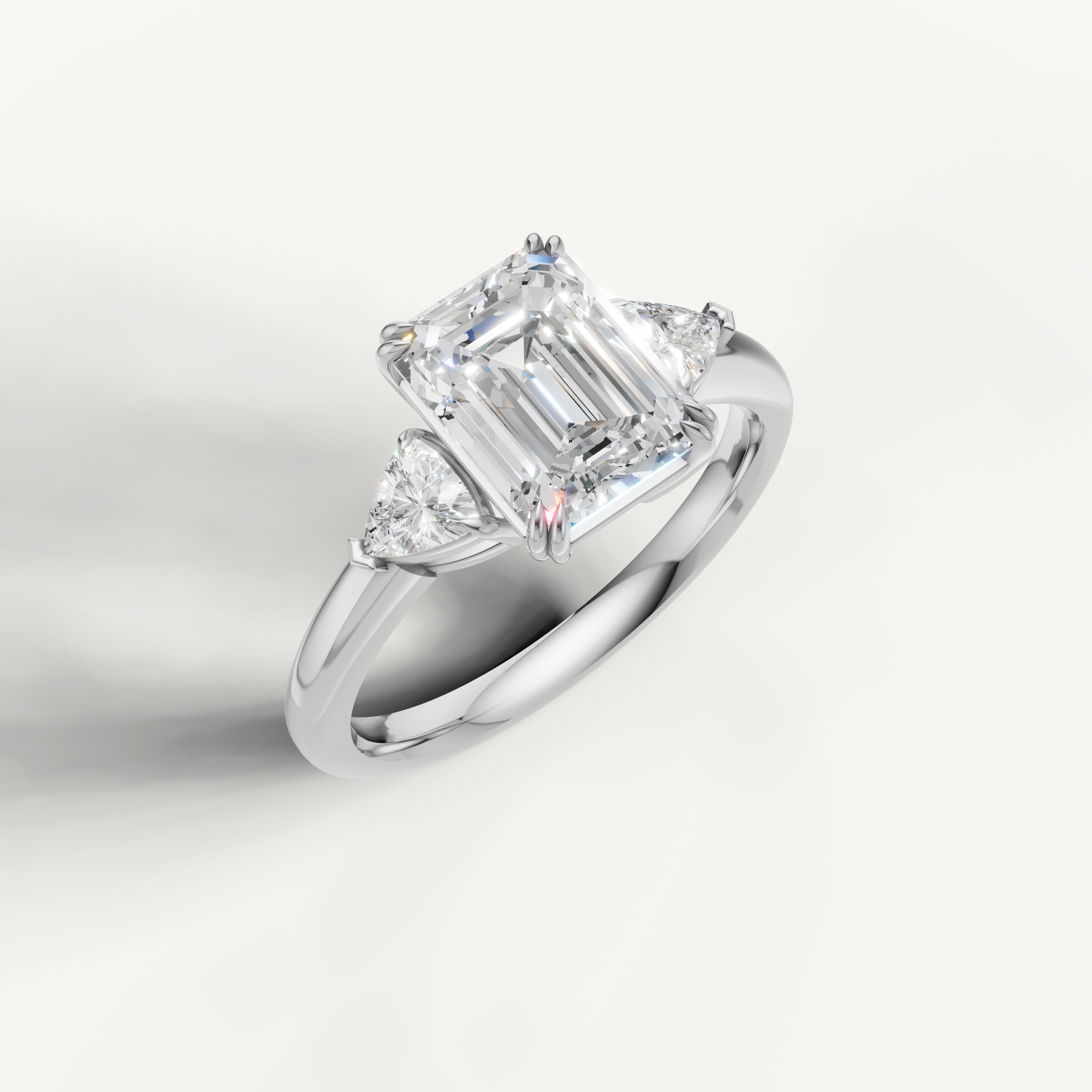 luxurious emerald cut lab grown diamond trilogy ring with brilliant trillion side diamonds