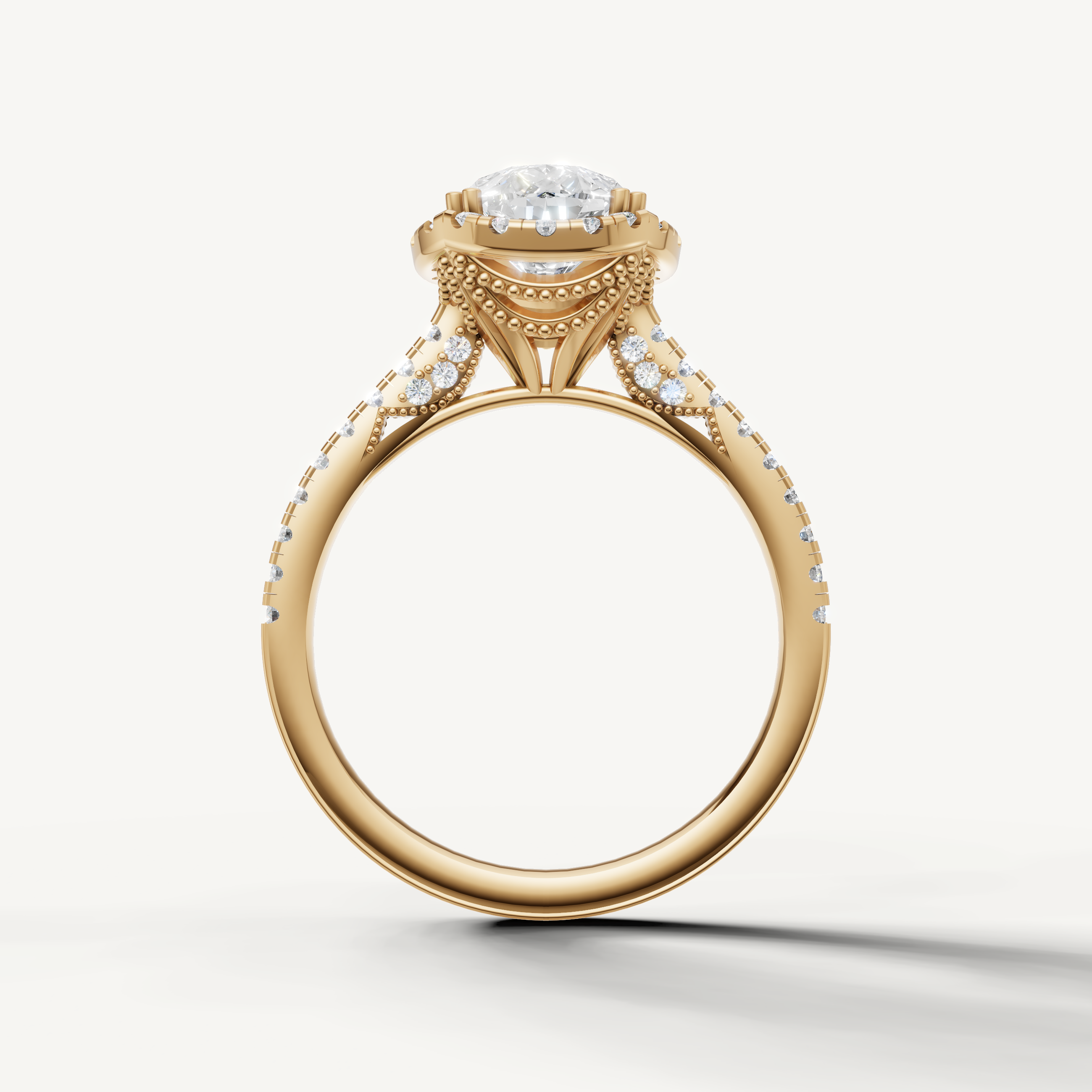 Luxury pear cut lab grown diamond halo ring in yellow gold with modern pavé detailing by Raul Diamonds